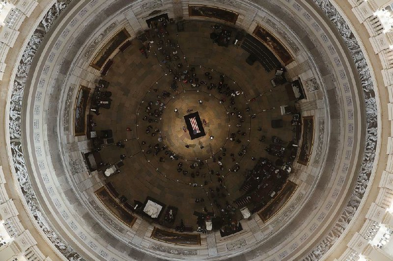 Former President George H. W. Bush lies in state in the U.S. Capitol Rotunda on Tuesday in Washington. A lifelong Episcopalian, Bush is credited by some for helping move Republicans toward conservative Christianity. 
