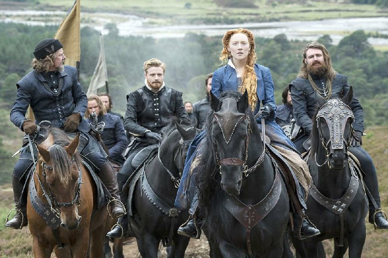 Henry Darnley (Jack Lowden, second from left) accompanies his Queen Mary (Saoirse Ronan) — who is also his wife and his second cousin — in Josie Rourke’s Mary Queen of Scots.