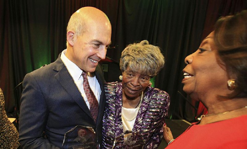 Honorees Matthew Waller and Annie Abrams (center) talk Wednesday with event chairman Lottie Shackelford after the Urban League of Arkansas’ Whitney M. Young Awards luncheon. 