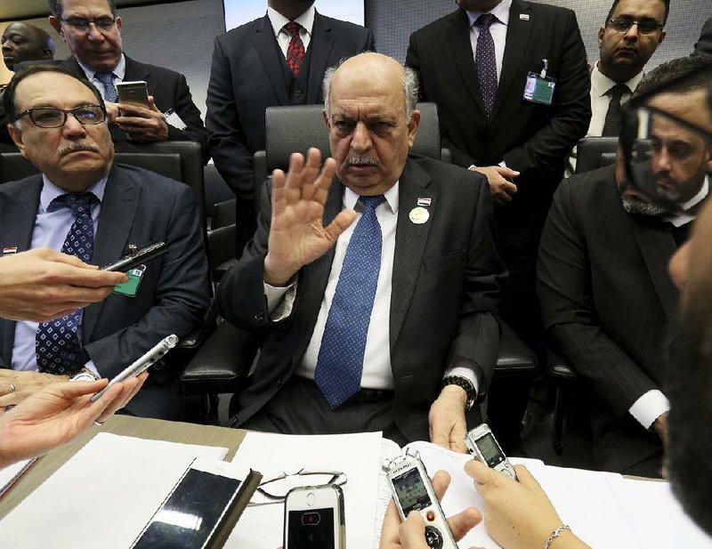 Iraqi oil minister Thamir Abbas Al Ghadhban speaks to reporters Thursday before the OPEC meeting in Vienna. 