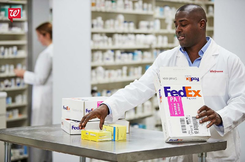 A Walgreens pharmacy worker prepares a prescription for delivery Thursday with FedEx. Walgreens and FedEx began a partnership last year. 