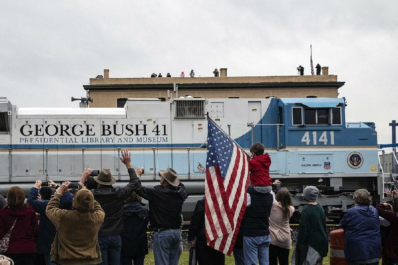 Union Pacific locomotive 4141 pulls the presidential funeral train through Navasota, Texas, on Thursday. 