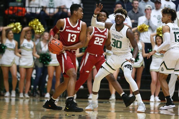 Arkansas' Mason Jones (13) looks to pass the ball while Colorado State's Kris Martin (30) defends during a game Wednesday, Dec. 5, 2018, in Fort Collins, Colo. 