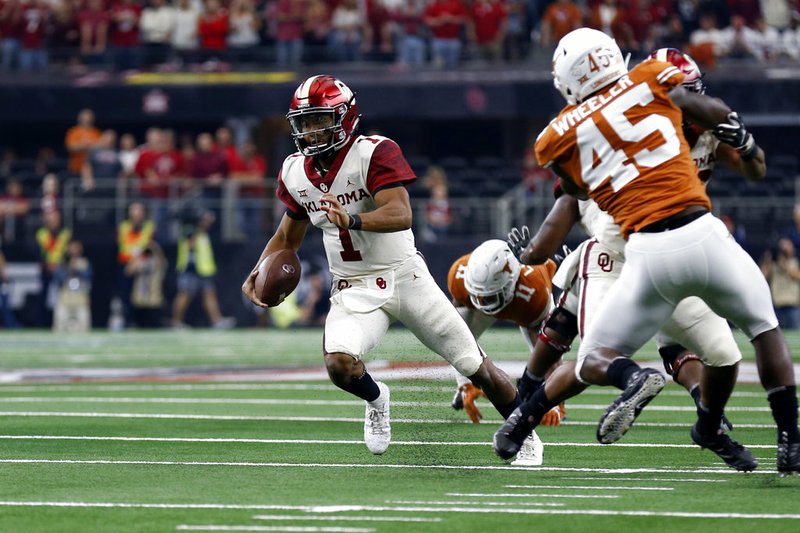 The Associated Press PLAYER OF THE YEAR: Oklahoma Sooners quarterback Kyler Murray (1) looks for room to run against the Texas Longhorns during the first half of the NCAA Big 12 Conference championship Saturday in Arlington, Texas. Murray was named The Associated Press college football Player of the Year Thursday.