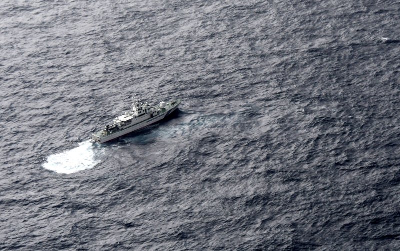 In this aerial photo, Japan's Coast Guard ship is seen at sea during a search operation for U.S. Marine refueling plane and fighter jet off Muroto, Kochi prefecture, southwestern Japan, Thursday, Dec. 6, 2018. (Kyodo News via AP)