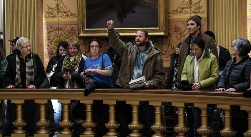 In this Tuesday, Dec. 4, 2018, photo, people take turns speaking to protest the lame duck legislation in the Capitol Rotunda in Lansing, Mich. The incoming Democratic governor of Wisconsin said Wednesday that he plans to make a personal appeal to his defeated rival, Gov. Scott Walker, to veto far-reaching GOP legislation that would restrict the new administration's powers. (Robert Killips/Lansing State Journal via AP)