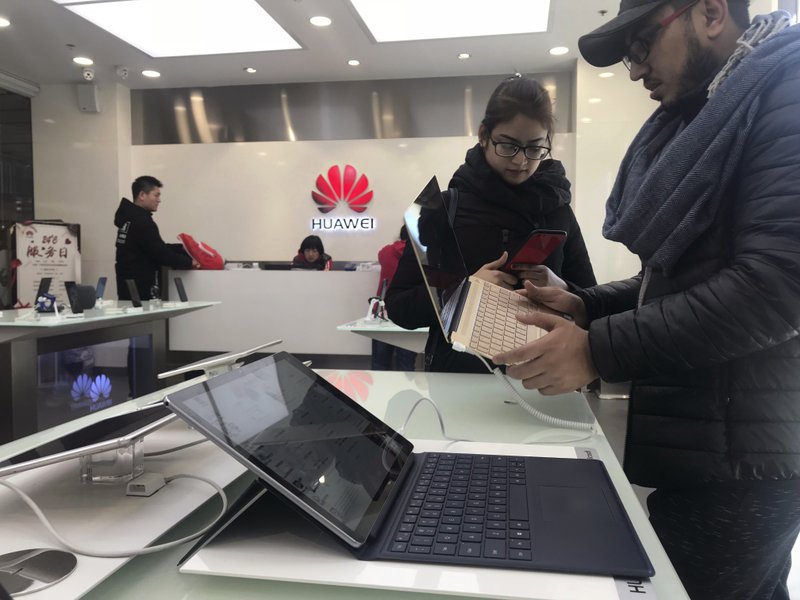 Customers look at a Huawei computer Thursday at a Huawei store in Beijing, China. Canadian authorities said Wednesday that they have arrested the chief financial officer of China’s Huawei Technologies for possible extradition to the United States.