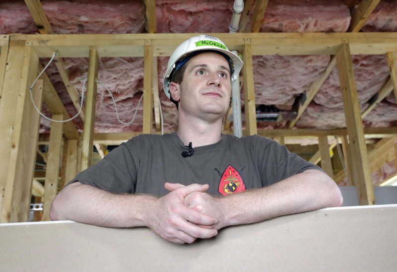 In this Sept. 26, 2018, file photo, Democratic congressional candidate Dan McCready leans against wallboard as he pauses during a Habitat For Humanity building event in Charlotte, N.C. The nation's last unresolved fall congressional race with McCready against Republican Mark Harris is awash in doubt as North Carolina election investigators concentrate on a rural county where absentee-ballot fraud allegations are so flagrant they've put the Election Day result into question. (AP Photo/Chuck Burton, File)
