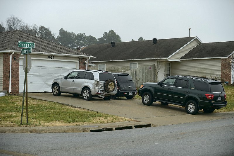 Cars sit Thursday, Dec. 6, 2018, in front of a house at 1659 Pioneer St. in Springdale. A 19-year-old man was found dead from an apparent gunshot wound Thursday, according to a news release from the Springdale Police Department.