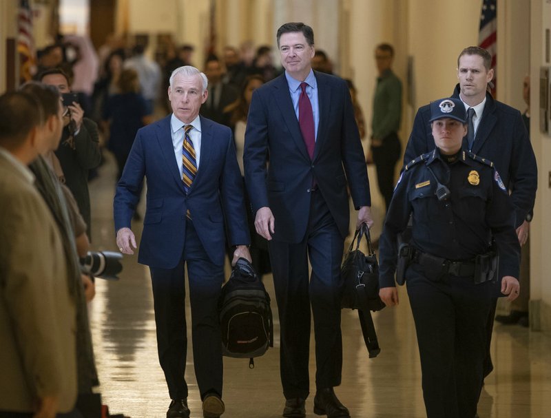 Former FBI Director James Comey, with his attorney, David Kelley, left, arrive to testify under subpoena behind closed doors before the House Judiciary and Oversight Committee on Capitol Hill in Washington, Friday, Dec. 7, 2018. (AP Photo/J. Scott Applewhite)