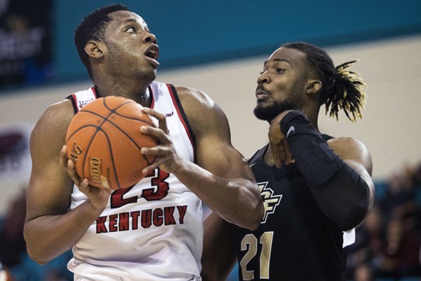 Western Kentucky center Charles Bassey (23) drives while guarded by Central Florida forward Chad Brown (21) during an NCAA college basketball game in the Myrtle Beach Invitational on Sunday, Nov. 18, 2018, in Conway, S.C. (Austin Anthony/Daily News via AP)

