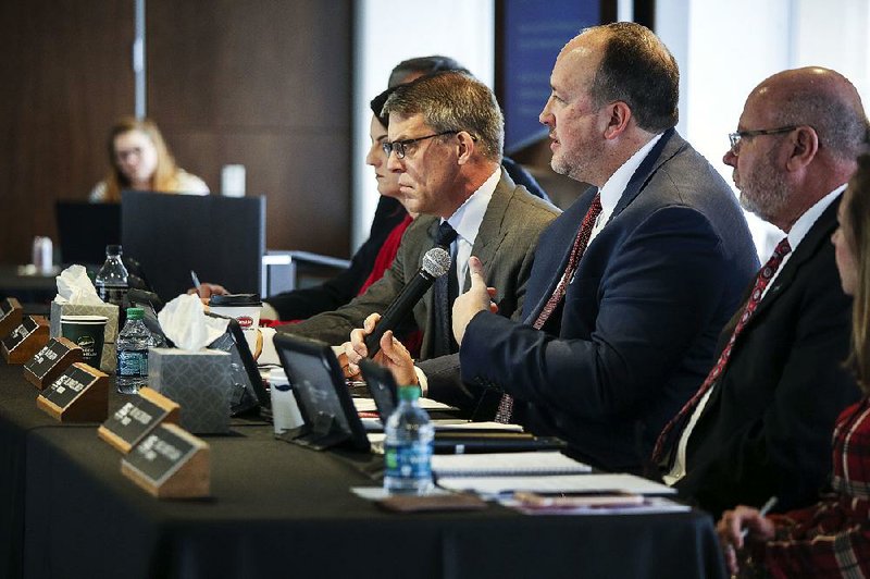 Arkansas State University System President Charles Welch (third from right) said at Friday’s board of trustees meeting that the system was “proud” of the Jonesboro campus’ journalism program. 