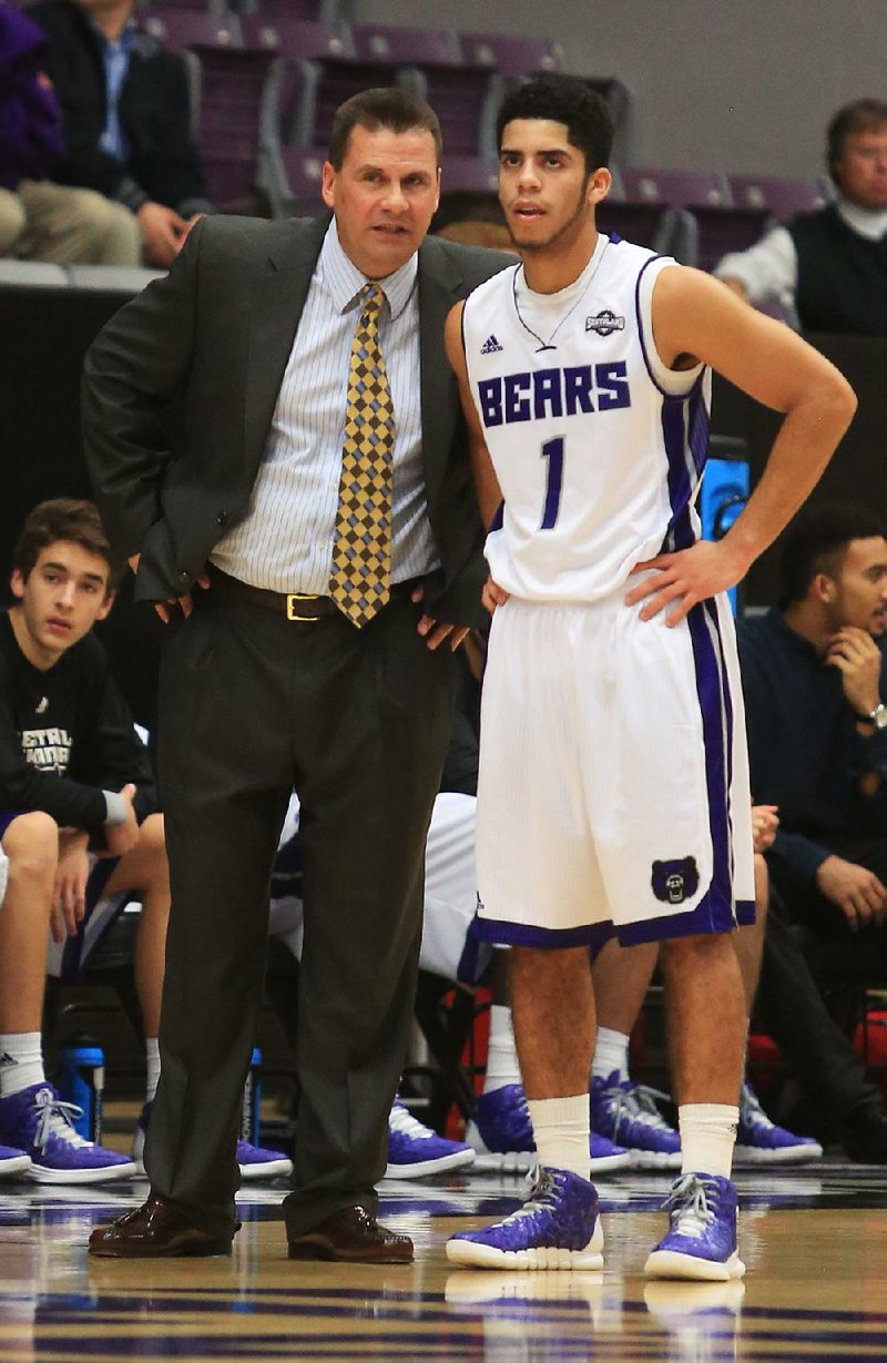 UCA head basketball coach Russ Pennell talks with Jordan Howard during their game with ASU at the Farris Center in Conway Monday on Dec. 1, 2014