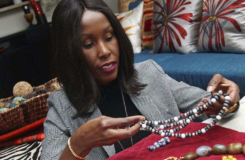 In this photo taken earlier this month, Shamila Nduriri, who owns Dalasini, an upscale jewelry company, holds some of her jewelry in her Minneapolis apartment. 
