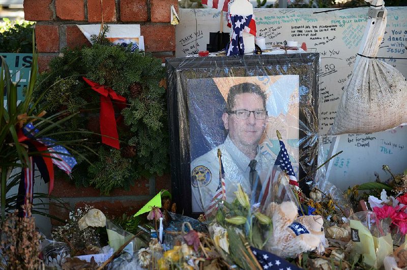 A photo of Sgt. Ron Helus adorns a memorial in Thousand Oaks, Calif. 