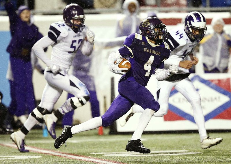 Junction City’s Jakiron Cook (4) runs past Hazen’s Boomsey Minor (44) and Kade Perry on a 63-yard touchdown reception in the fourth quarter of Friday night’s Class 2A championship game at War Memorial Stadium in Little Rock.