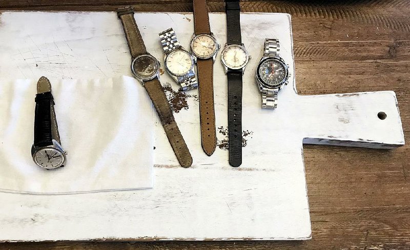 Watches lie on a cutting board that is used as a photo backdrop at Christian Zeron’s company Theo & Harris in Westfield, N.J., on May 31. Zeron’s company website, theoandharris.com, sells $2 million worth of secondhand watches annually. 