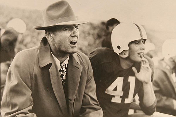 Arkansas coach John Barnhill and player Buddy Sutton watch from the sidelines during an undated game at War Memorial Stadium in Little Rock in 1949. The photo is the cover of the new collector's book "Footsteps Have Trod: 125 Seasons of Arkansas Football."