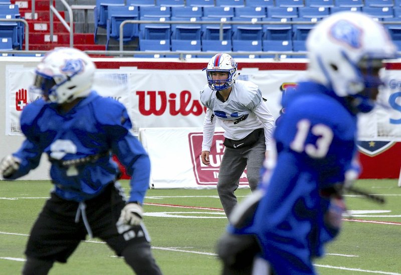 Arkansas Democrat-Gazette/Mitchell Pe Masilun DRILL SESSION: Arkadelphia's Cannon Turner (21) runs through practice with his teammates Thursday at War Memorial Stadium in Little Rock. The Badgers are seeking their fourth state title today against conference foe Joe T. Robinson, who defeated the Badgers, 42-14, in the fifth game of the season.