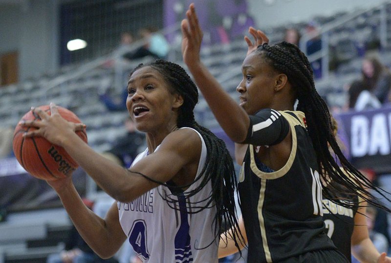 NWA Democrat-Gazette/ANDY SHUPE Fayetteville guard Coriah Beck (left) makes a move around Jonesboro forward Destiny Salary Friday, Dec. 7, 2018, during the first half of play in Bulldog Arena. Visit nwadg.com/photos to see more photographs from the game.