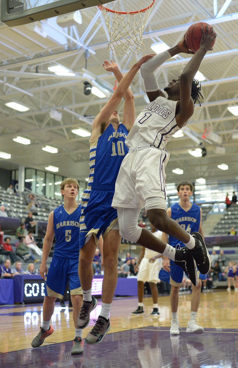 NWA Democrat-Gazette/ANDY SHUPE Fayetteville forward Austin Garrett (1) reaches to score over Harrison forward Carson Journagan (10) Friday, Dec. 7, 2018, during the first half of play in Bulldog Arena. Visit nwadg.com/photos to see more photographs from the game.