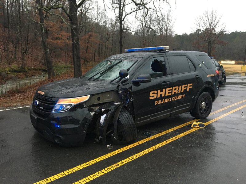 A Pulaski County sheriff's office SUV sits at the site of a crash Saturday near Camp Robinson just outside North Little Rock. 