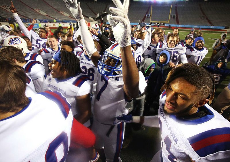 Arkadelphia players celebrate after Saturday night’s victory over Joe T. Robinson in the Class 4A championship game at War Memorial Stadium in Little Rock. The Badgers won their second consecutive state title and their fourth overall.