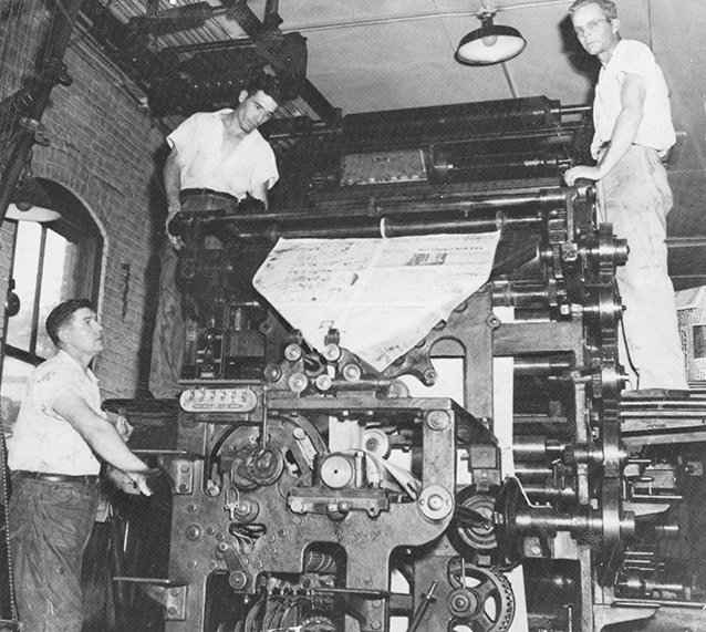 Submitted photo PRESSROOM: From left, Archie Lawler, Houston "Tiny" Smith and Grady Geer work in the pressroom of The Sentinel-Record/New Era building at 912 Central Ave. in 1952. The Garland County Historical Society's journal, The Record 2018, examines the history of the newspapers and presents the recollections of Bobby Anderson, who worked as a newspaper boy as he grew up in Hot Springs in the 1950s.