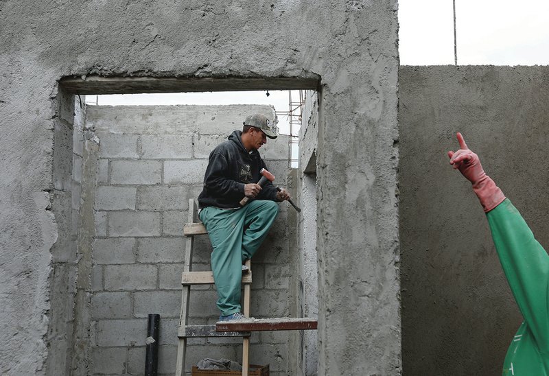 The Associated Press DAY LABORER: Honduran migrant Reyes Franco, 39, works as a day laborer at a construction site Wednesday in Tijuana, Mexico. Mexican authorities have encouraged all of the migrants to regularize their status in Mexico and seek work.