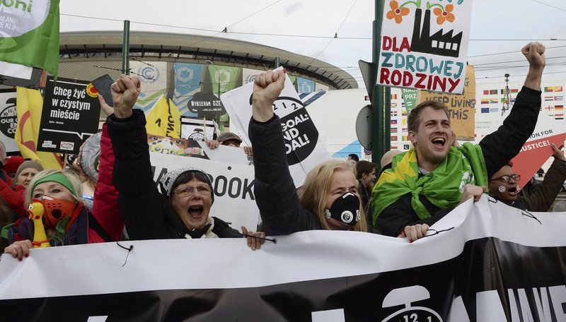 Climate activists shout slogans as they stop in front of the COP24 UN Climate Change Conference venue during the March for Climate in a protest against global warming in Katowice, Poland, Saturday, Dec. 8, 2018. (AP Photo/Alik Keplicz)