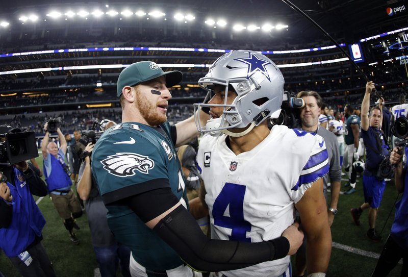 FILE - In this Nov. 19, 2017, file photo, Philadelphia Eagles' Carson Wentz, left, and Dallas Cowboys' Dak Prescott, right, greet each other after their NFL football game, in Arlington, Texas. Prescott and the Cowboys saved their season with a win in Philadelphia a month ago. Now Carson Wentz and the defending champion Eagles are trying to do the same in Texas against first-place Dallas on Sunday. (AP Photo/Ron Jenkins, File)