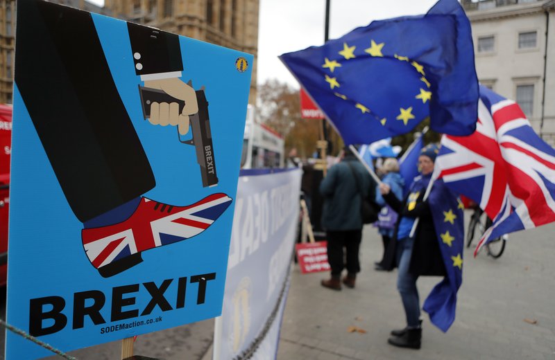 Protestors demonstrate opposite Parliament against Britain's Brexit split from Europe, in London, Thursday, Dec. 6, 2018. Britain's Prime Minister Theresa May's effort to win support for her Brexit agreement comes amid reports in British newspapers Thursday, predicting that Parliament could reject the deal by more than 100 votes. (AP Photo/Frank Augstein)