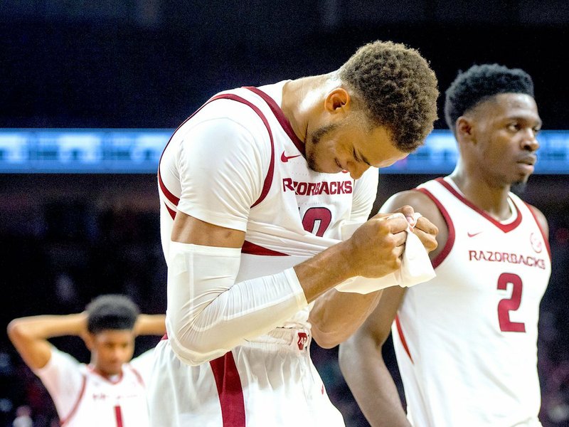 NWA Democrat-Gazette/Ben Goff HOGS TOPPED: Arkansas Razorbacks Daniel Gafford, left, and Adrio Bailey (2) leave the court at Bud Walton Arena Saturday in Fayetteville after a 78-77 loss to the Western Kentucky Hilltoppers.