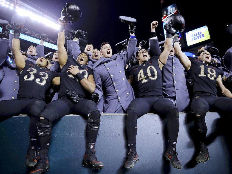 The Associated Press 3-PEAT: Army college football players celebrate a third straight victory over Navy, 17-10, on Saturday in Philadelphia.
