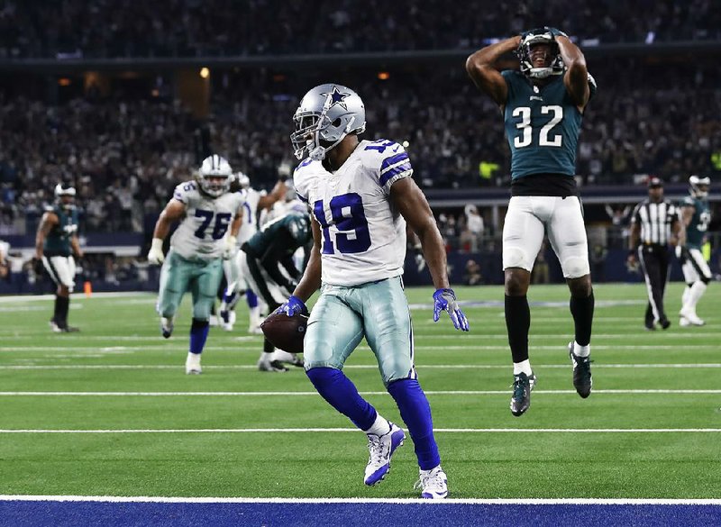 Dallas wide receiver Amari Cooper scores in overtime as Rasul Douglas of the Philadelphia Eagles watches, giving the Cowboys a 29-23 victory Sunday in Arlington, Texas. Cooper finished with 10 catches for 217 yards and 3 touchdowns in his second game in the past three with at least 180 yards and 2 scores.