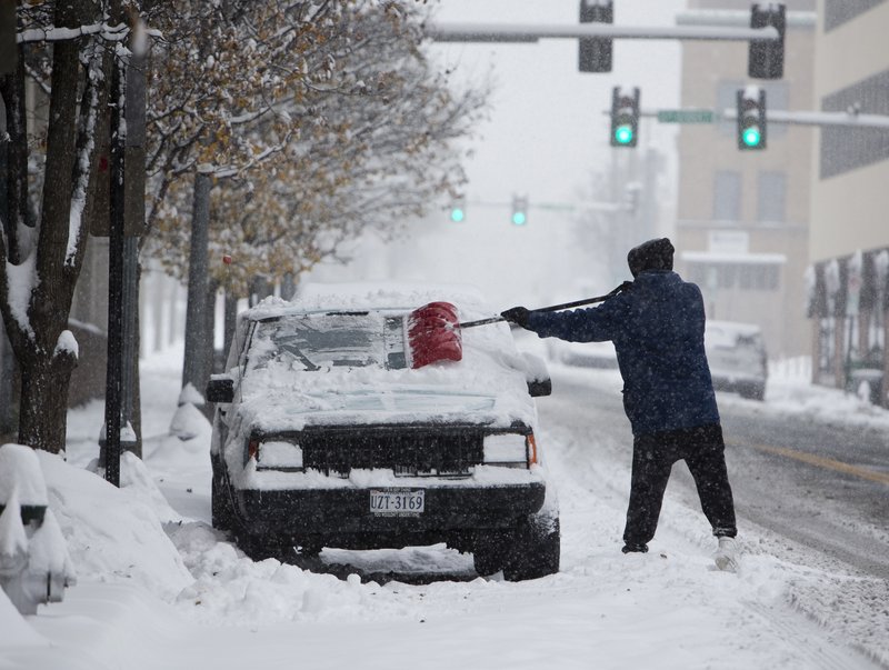 John Woodrum, shovels his car on Sunday, Dec. 9, 2018, in Roanoke, Va. A massive storm brought snow, sleet, and freezing rain across a wide swath of the South on Sunday &#x2014; causing dangerously icy roads, immobilizing snowfalls and power losses to hundreds of thousands of people. (Stephanie Klein-Davis /The Roanoke Times via AP)