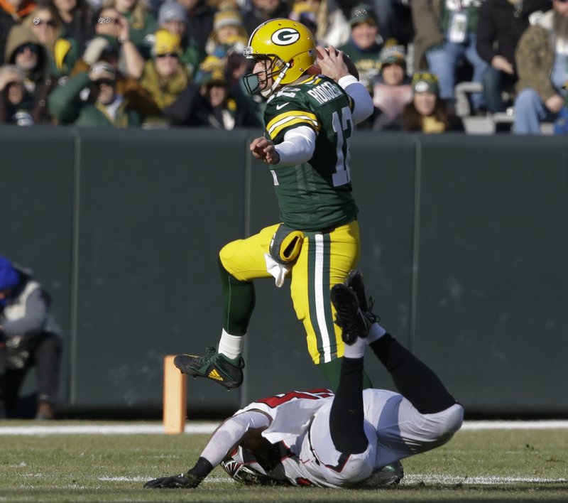 Green Bay Packers' Aaron Rodgers scrambles during the first half of an NFL football game against the Atlanta Falcons Sunday, Dec. 9, 2018, in Green Bay, Wis. (AP Photo/Jeffrey Phelps)