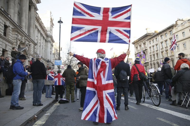 Demonstrators hold placards and flags at the "Brexit Betrayal Rally", a pro-Brexit rally, on Whitehall in London, Sunday Dec. 9, 2018. With a crucial parliamentary vote on Brexit looming, British Prime Minister Theresa May warned lawmakers Sunday that they could take Britain into "uncharted waters" and trigger a general election if they reject the divorce deal she struck with the European Union. (AP Photo/Tim Ireland)

