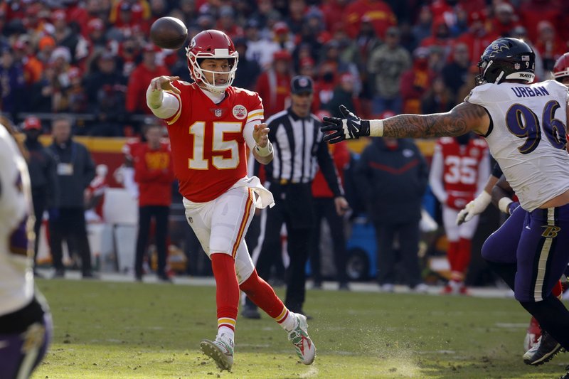 Kansas City Chiefs quarterback Patrick Mahomes (15) throws on the run past Baltimore Ravens defensive end Brent Urban (96) during the first half of an NFL football game in Kansas City, Mo., Sunday, Dec. 9, 2018. (AP Photo/Charlie Riedel)