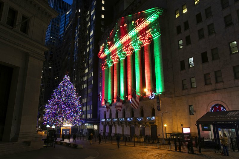 The New York Stock Exchange is bathed in holiday light, Tuesday, Dec. 11, 2018, in New York. (AP Photo/Mark Lennihan)