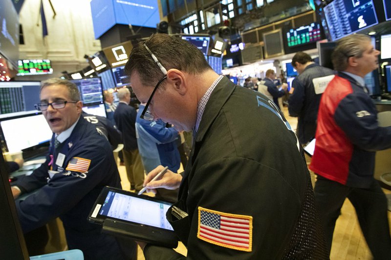 Traders work at the New York Stock Exchange, Tuesday, Dec. 11, 2018, in New York. Stock markets around the world spiked higher Tuesday after Wall Street rebounded amid hopes the U.S. and China are back negotiating over their trade dispute. (AP Photo/Mark Lennihan)