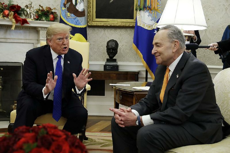 During what he later called “a friendly debate,” President Donald Trump spars with Senate Minority Leader Charles Schumer (right) about funding for a border wall with Mexico, telling him: “You don’t want to shut down the government, Chuck.” 