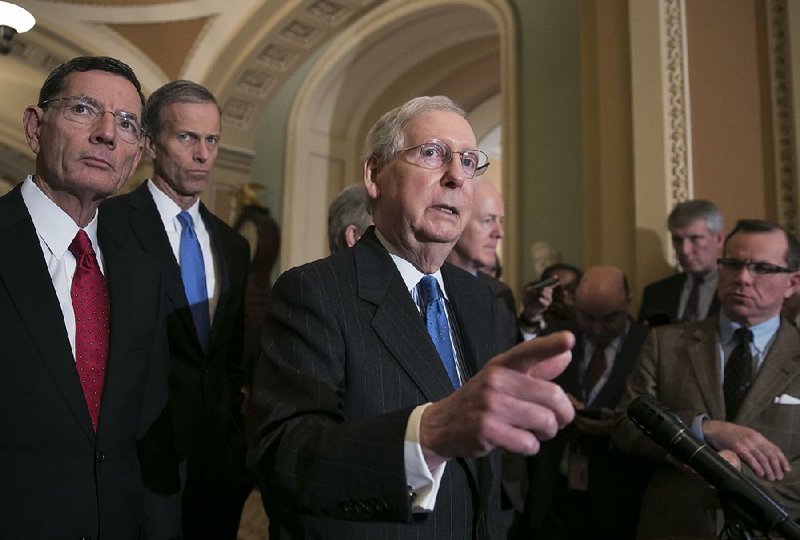 Senate Majority Leader Mitch McConnell, joined by fellow Republican Sens. John Barrasso of Wyoming and John Thune of South Dakota, speaks Tuesday after a strategy session at the Capitol in Washington. The Senate later approved the farm bill. 