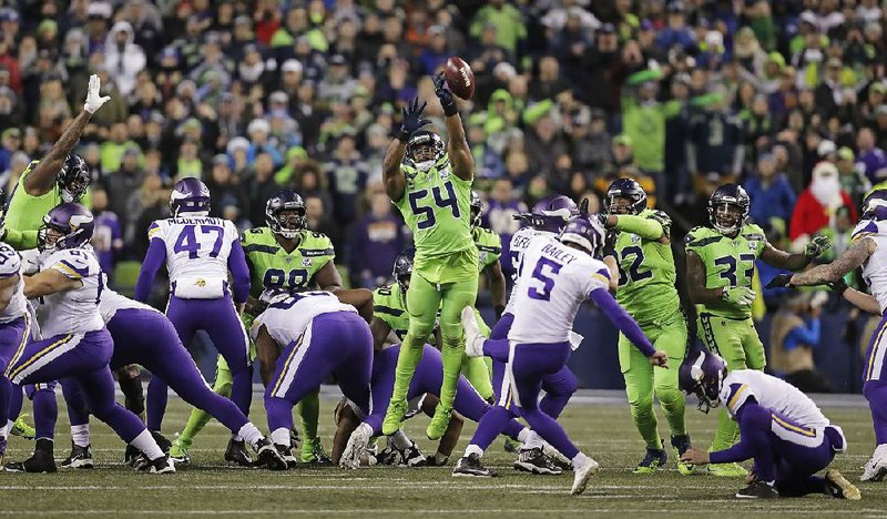 Linebacker Bobby Wagner (54) of the Seattle Seahawks leaps to block a field-goal attempt by Dan Bailey of Minnesota in the Seahawks’ 21-7 victory Monday night. The block became controversial as to whether Wagner used his hands to gain leverage off a teammate to block the kick. 