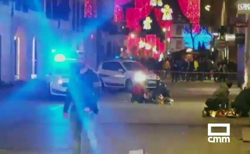 In this image made from video provided by CMM, people lie on the ground after a shooting at a Christmas market in Strasbourg, France, on Tuesday. 