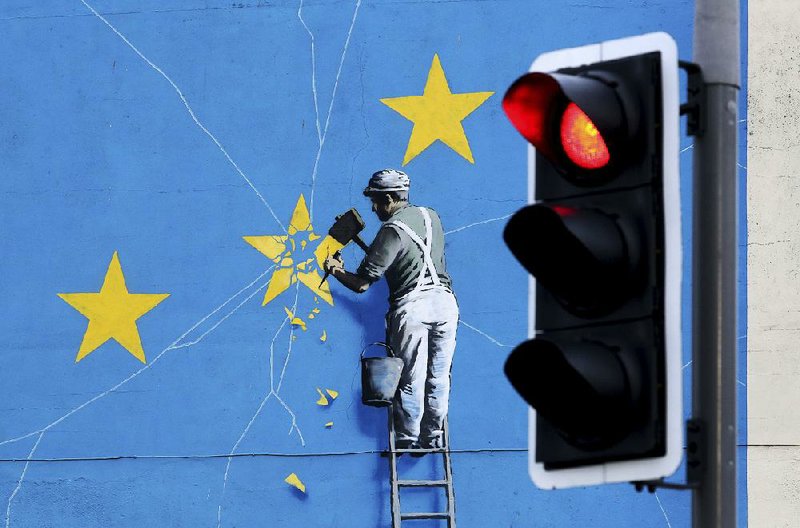 A view of the Banksy Brexit mural shows a man chipping away at the EU flag in Dover, England, on Tuesday. 
