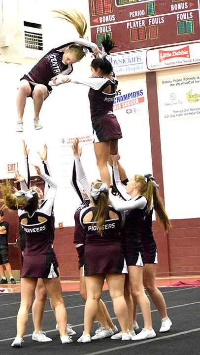 Westside Eagle Observer/MIKE ECKELS A Gentry cheerleader begins a dismount maneuver during the 2018 Pioneer Invitational Cheer Competition at Pioneer Gym in Gentry Dec. 6. The maneuver was successful as the team continued its routine.