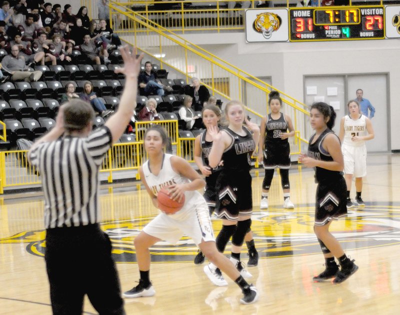 MARK HUMPHREY ENTERPRISE-LEADER A referee stops action spotting a foul while Prairie Grove sophomore Jasmine Wynos battles a trio of Lincoln players for control of the basketball. The Lady Tigers defeated their rival, 40-33, on Tuesday, Dec. 4, 2018.