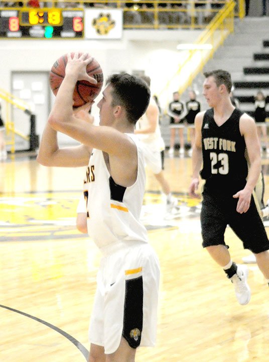 MARK HUMPHREY ENTERPRISE-LEADER Prairie Grove senor Riley Rhodes, shown shooting a 3-pointer in the first half, knocked down the game-winning 3-point shot with seconds to go lifting the Tigers to a thrilling 46-43 win over West Fork on Friday, Dec. 7, 2018.
