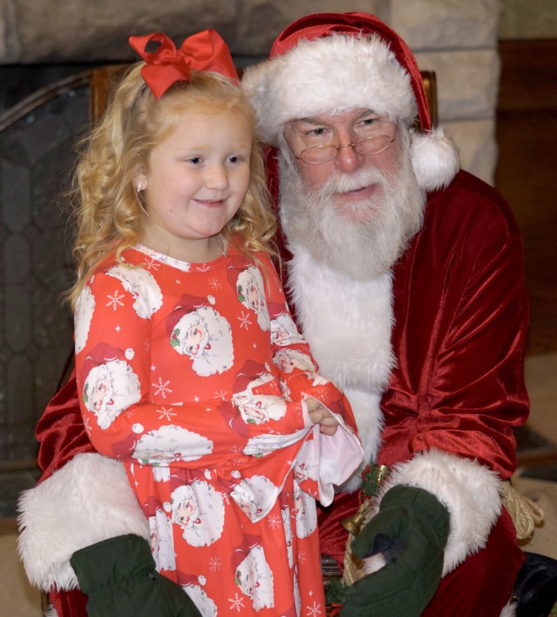 Westside Eagle Observer/RANDY MOLL Makenzie Jech, 5, visits with Santa Claus at the Gentry Chamber of Commerce office in downtown Gentry on Saturday afternoon.